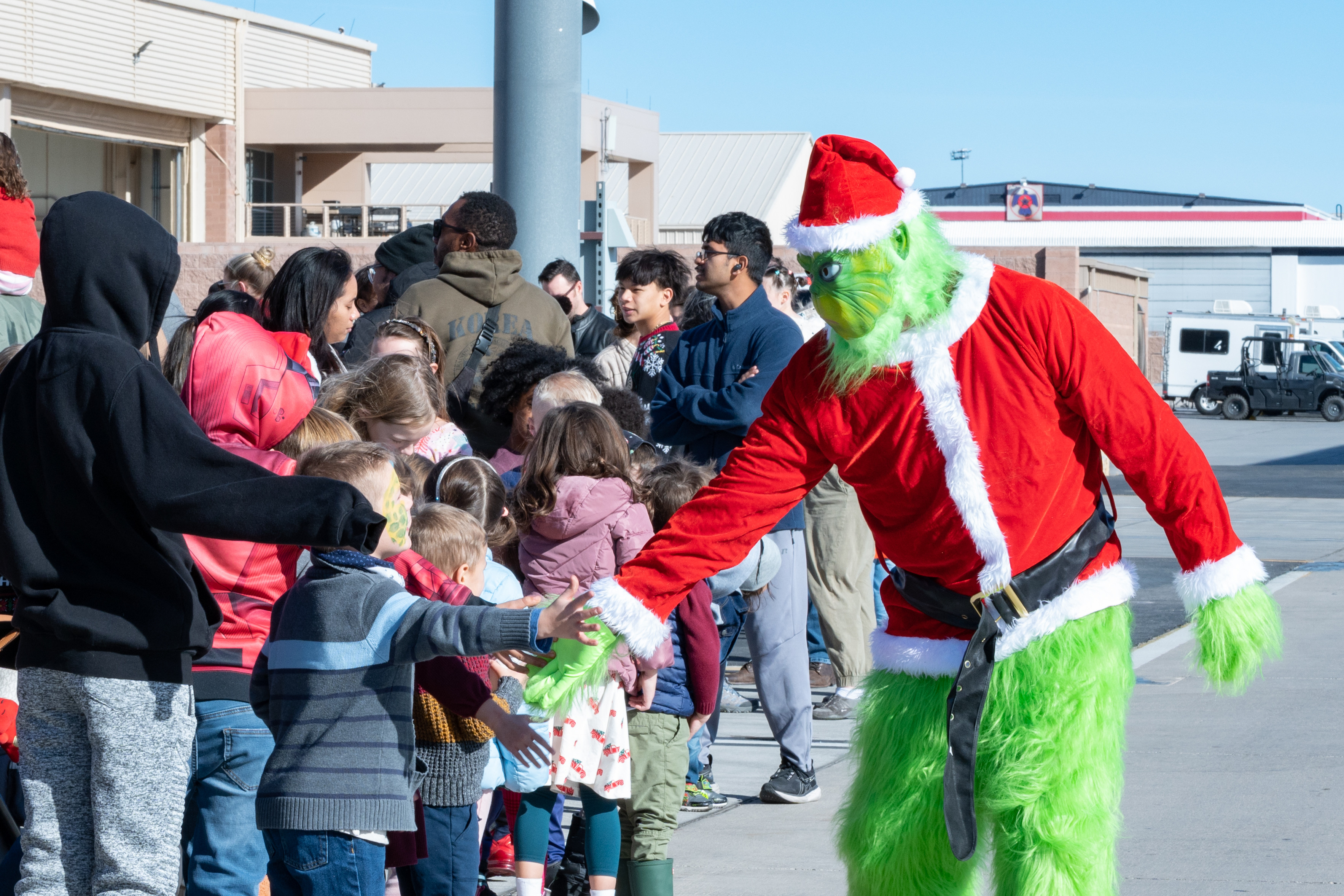 U.S. Air Force Lt. Col. Adam Clift dresses as the Grinch and greets children of the United States Air Force Weapons School’s unit members at a holiday party at Nellis Air Force Base, Nevada, Dec. 9, 2023. The party was hosted as a means to build and strengthen morale between the weapons school and its Airmen. (U.S. Air Force photo by Airman 1st Class Elizabeth Tan)