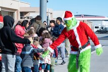 U.S. Air Force Lt. Col. Adam Clift dresses as the Grinch and greets children of the United States Air Force Weapons School’s unit members at a holiday party at Nellis Air Force Base, Nevada, Dec. 9, 2023.