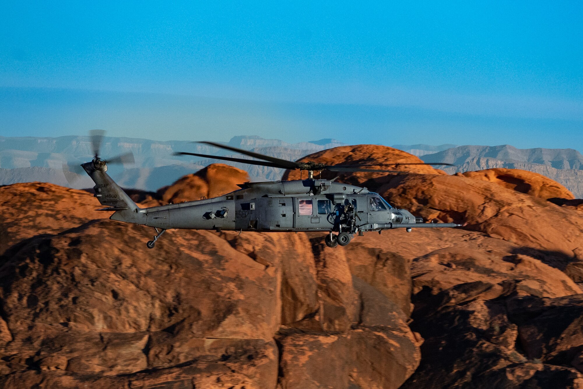 An HH-60W Jolly Green II flies over the Valley of Fire as part of a 53rd Wing Civic Leader flight from Nellis Air Force Base, Nevada, Dec. 12, 2023.