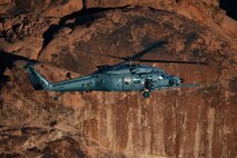 An HH-60W Jolly Green II flies over the Valley of Fire as part of a 53rd Wing Civic Leader flight from Nellis Air Force Base, Nevada, Dec. 12, 2023.