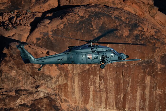 An HH-60W Jolly Green II flies over the Valley of Fire as part of a 53rd Wing Civic Leader flight from Nellis Air Force Base, Nevada, Dec. 12, 2023.