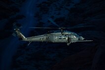 An HH-60W Jolly Green II flies over the Valley of Fire as part of a 53rd Wing Civic Leader flight from Nellis Air Force Base, Nevada, Dec. 12, 2023.