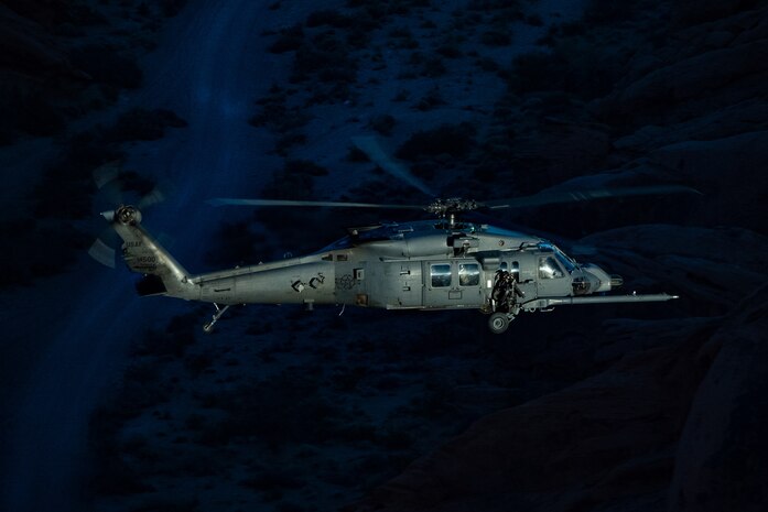 An HH-60W Jolly Green II flies over the Valley of Fire as part of a 53rd Wing Civic Leader flight from Nellis Air Force Base, Nevada, Dec. 12, 2023.
