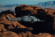 An HH-60W Jolly Green II flies over the Valley of Fire as part of a 53rd Wing Civic Leader flight from Nellis Air Force Base, Nevada, Dec. 12, 2023.