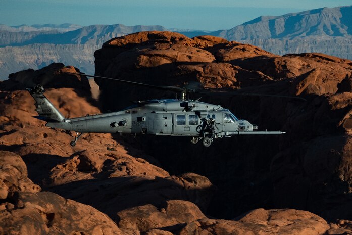 An HH-60W Jolly Green II flies over the Valley of Fire as part of a 53rd Wing Civic Leader flight from Nellis Air Force Base, Nevada, Dec. 12, 2023.