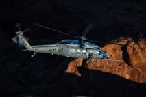 An HH-60W Jolly Green II flies over the Valley of Fire as part of a 53rd Wing Civic Leader flight from Nellis Air Force Base, Nevada, Dec. 12, 2023.