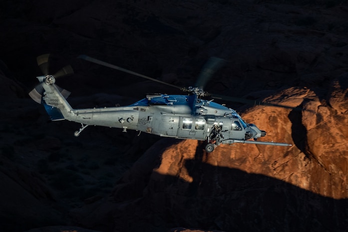 An HH-60W Jolly Green II flies over the Valley of Fire as part of a 53rd Wing Civic Leader flight from Nellis Air Force Base, Nevada, Dec. 12, 2023.