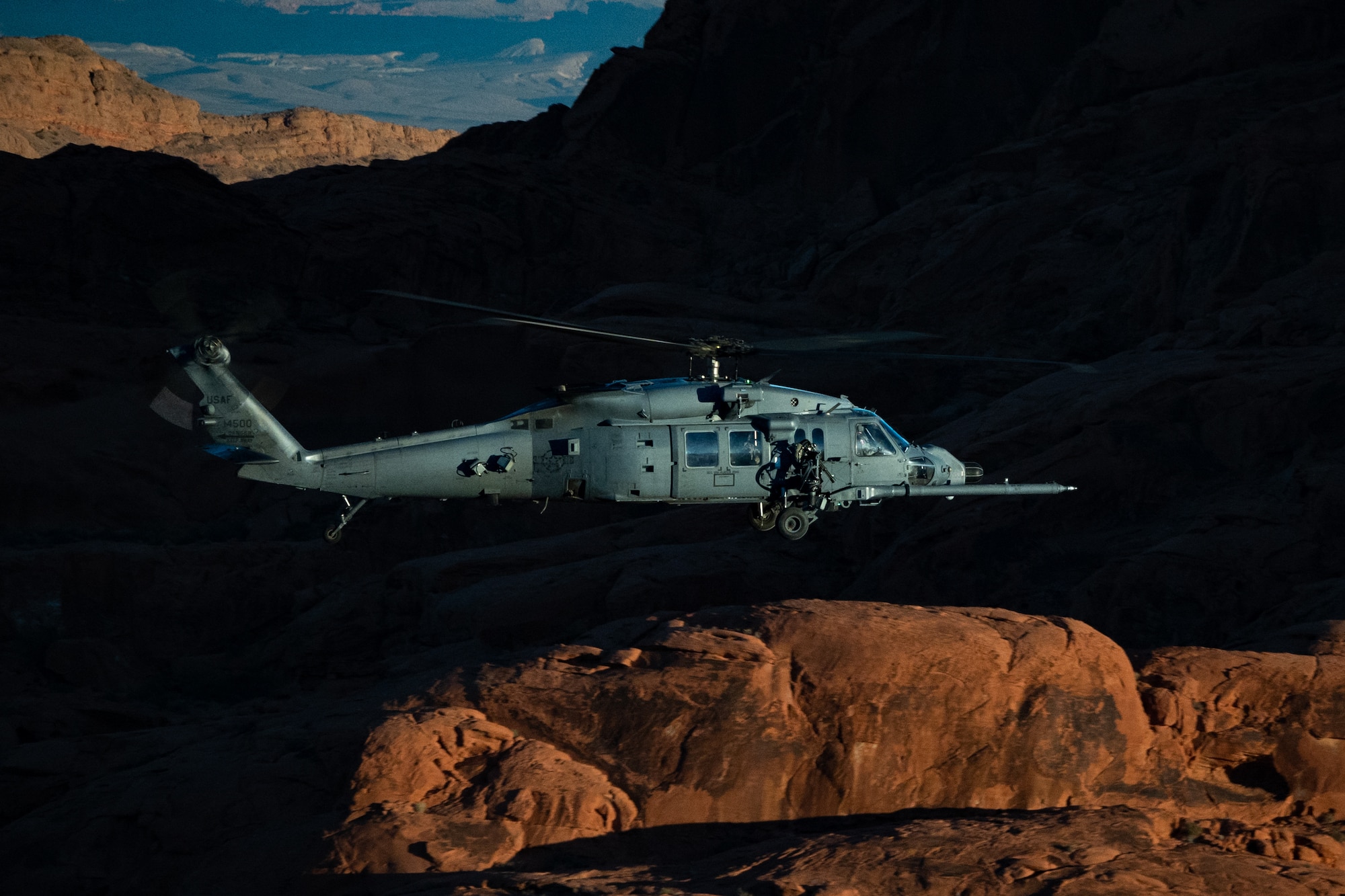 An HH-60W Jolly Green II flies over the Valley of Fire as part of a 53rd Wing Civic Leader flight from Nellis Air Force Base, Nevada, Dec. 12, 2023.
