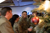 U.S. Air Force Airmen grab water during a Chief Master Sgt. select party in the Nellis Club at Nellis Air Force Base, Nevada, Dec. 7, 2023.