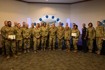 U.S. Air Force Airmen pose for a photograph during a Chief Master Sgt. select party in the Nellis Club at Nellis Air Force Base, Nevada, Dec. 7, 2023.