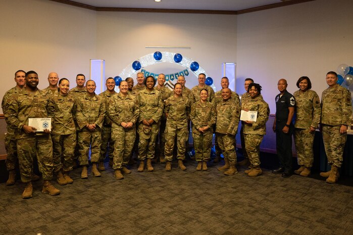U.S. Air Force Airmen pose for a photograph during a Chief Master Sgt. select party in the Nellis Club at Nellis Air Force Base, Nevada, Dec. 7, 2023.