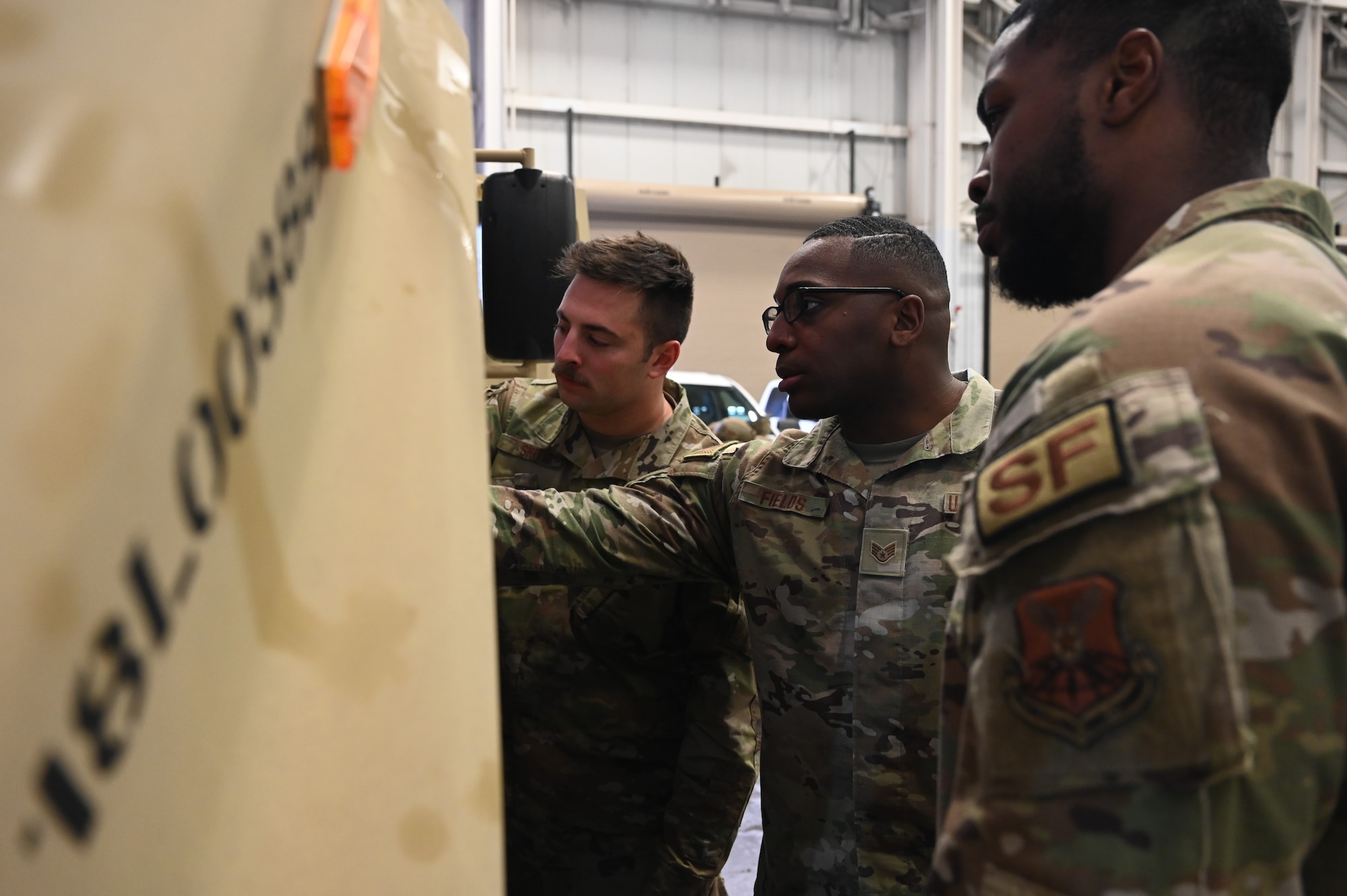 Security forces Airmen train on a new vehicle.