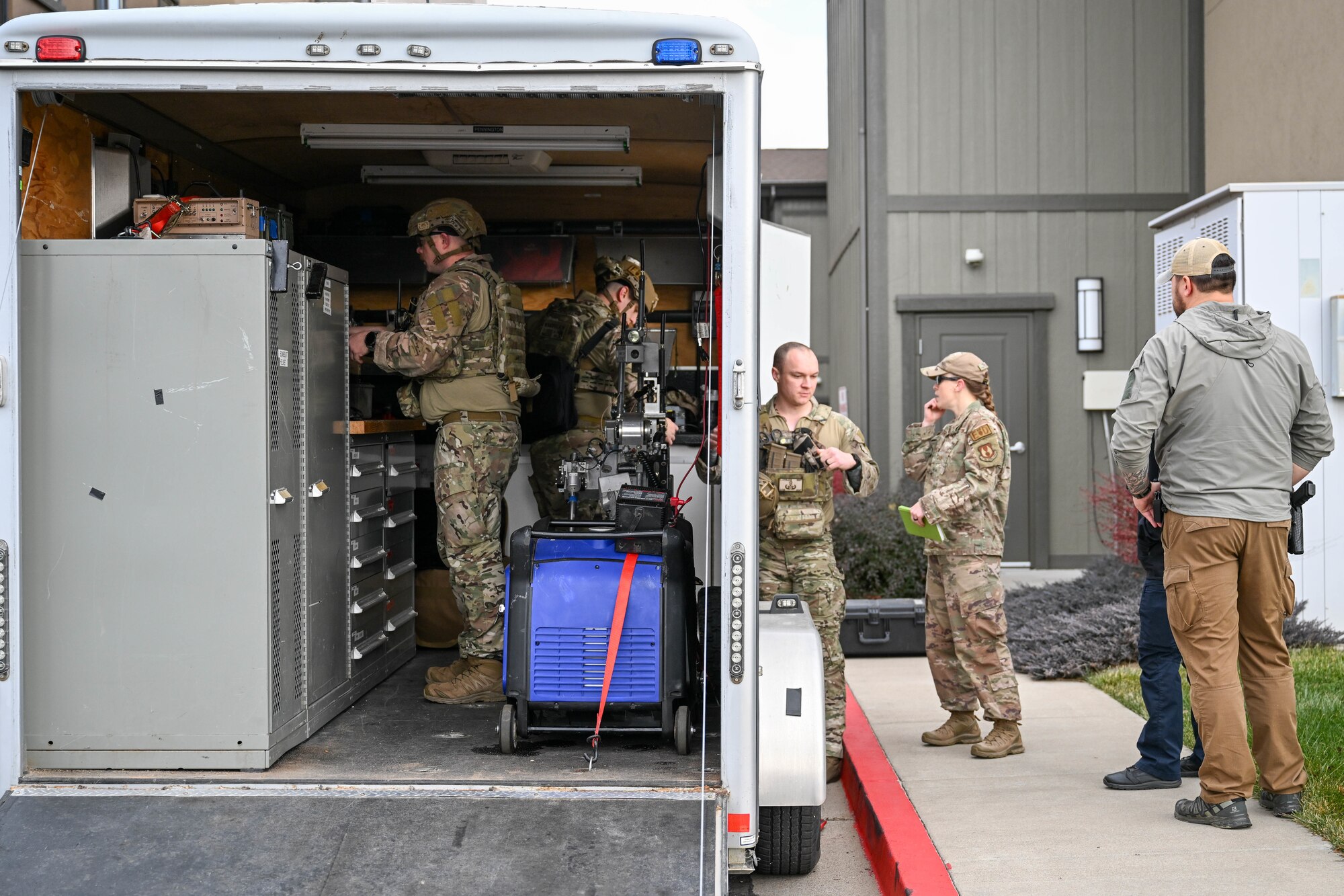 Technicians from 775th Explosive Ordnance Disposal Flight prepare tools and discuss strategies during a training exercise