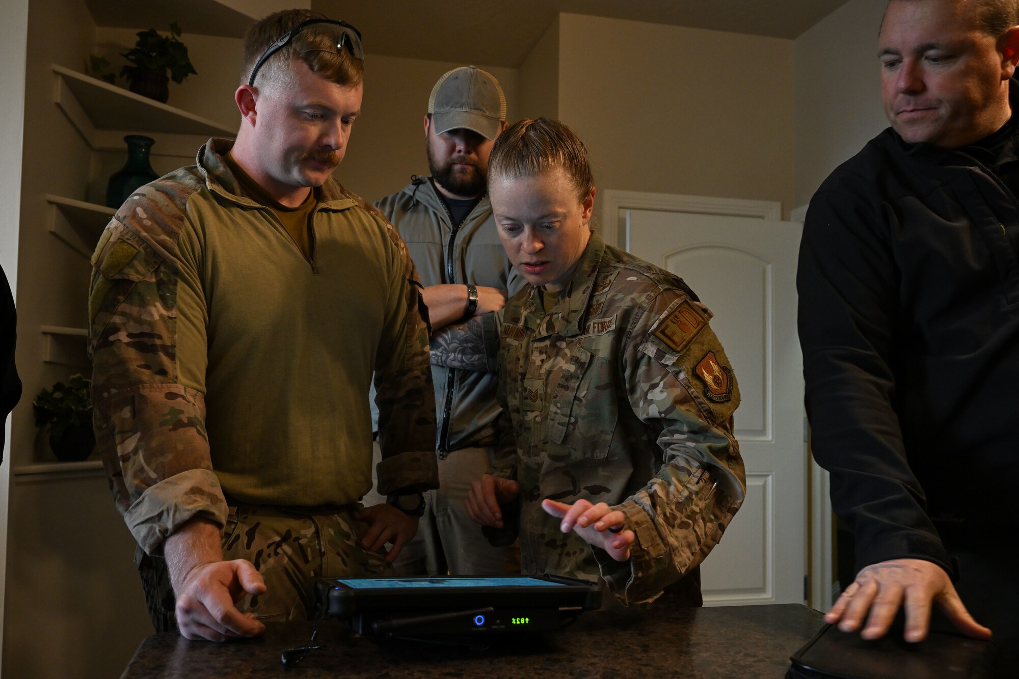 Senior Airman T.J. Miller and Tech. Sgt. Jessica Johnson, 775th Explosive Ordnance Disposal Flight, examine the X-ray of the simulated explosive device during a training exercise Dec. 20