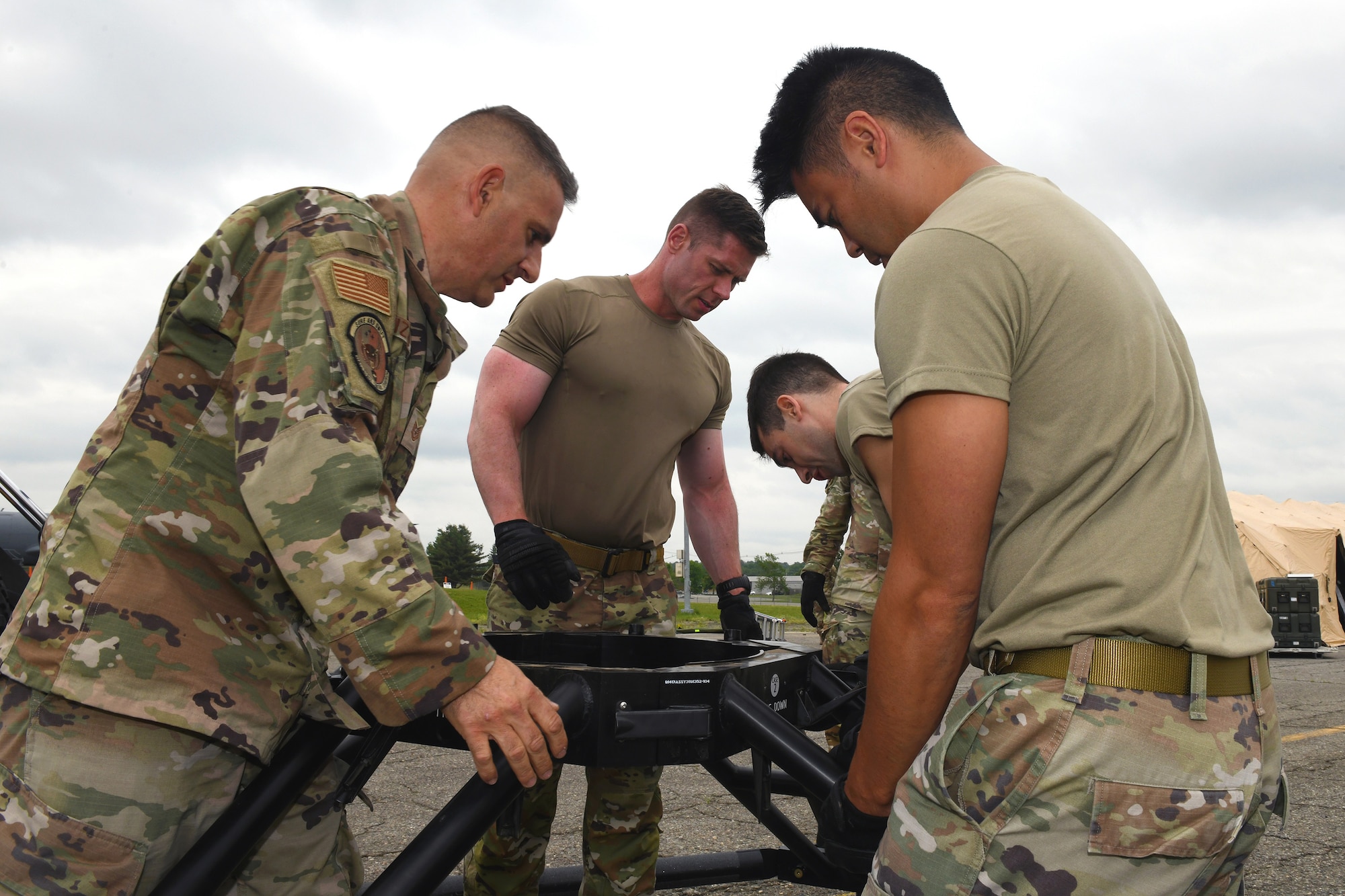 From left to right, Tech. Sgt. Salvatore Izzo, Tech. Sgt. Christopher Hodge, Staff Sgt. Christopher Jones and 1st Lt. Zachary Burns – all with the Florida Air National Guard’s 114th Electromagnetic Warfare Squadron – stabilize what will be the base of an antenna as part of exercise ThunderMoose, June 13, 2023, at Bangor Air National Guard Base in Maine.