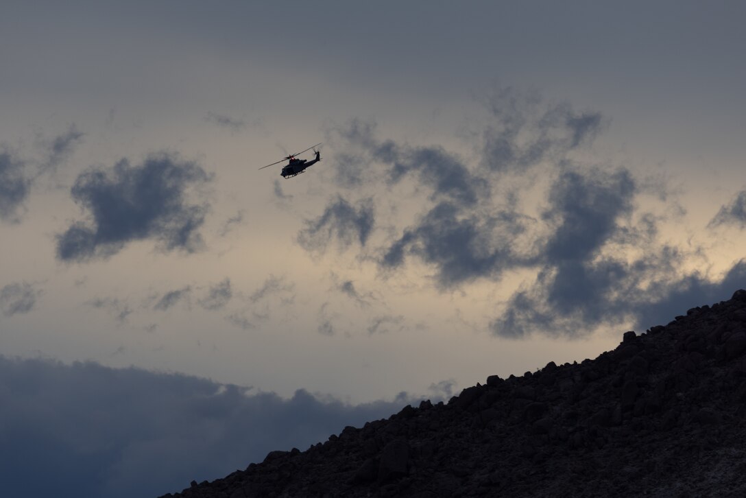 A U.S. Marine Corps UH-1Y Venom helicopter with Marine Light Attack Helicopter Squadron (HMLA) 267, Marine Aircraft Group 39, 3rd Marine Aircraft Wing, conducts close air support during a live-fire exercise during the Expeditionary Warfare Training Group Pacific’s Tactical Air Control Party course at Marine Corps Air Ground Combat Center Twentynine Palms, California, Dec. 19, 2023.  3rd MAW provided aircraft and aircrew to support EWTGPAC’s TACP course which trains joint and coalition officer and enlisted personnel to conduct terminal attack control of close air support. (U.S. Marine Corps photo by Lance Cpl. Samantha Devine)