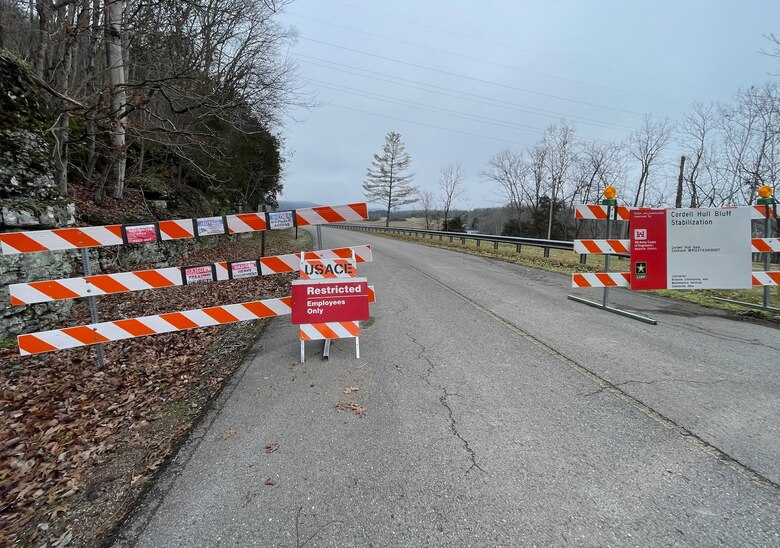 A road with red and white movable fences blocking the roads.