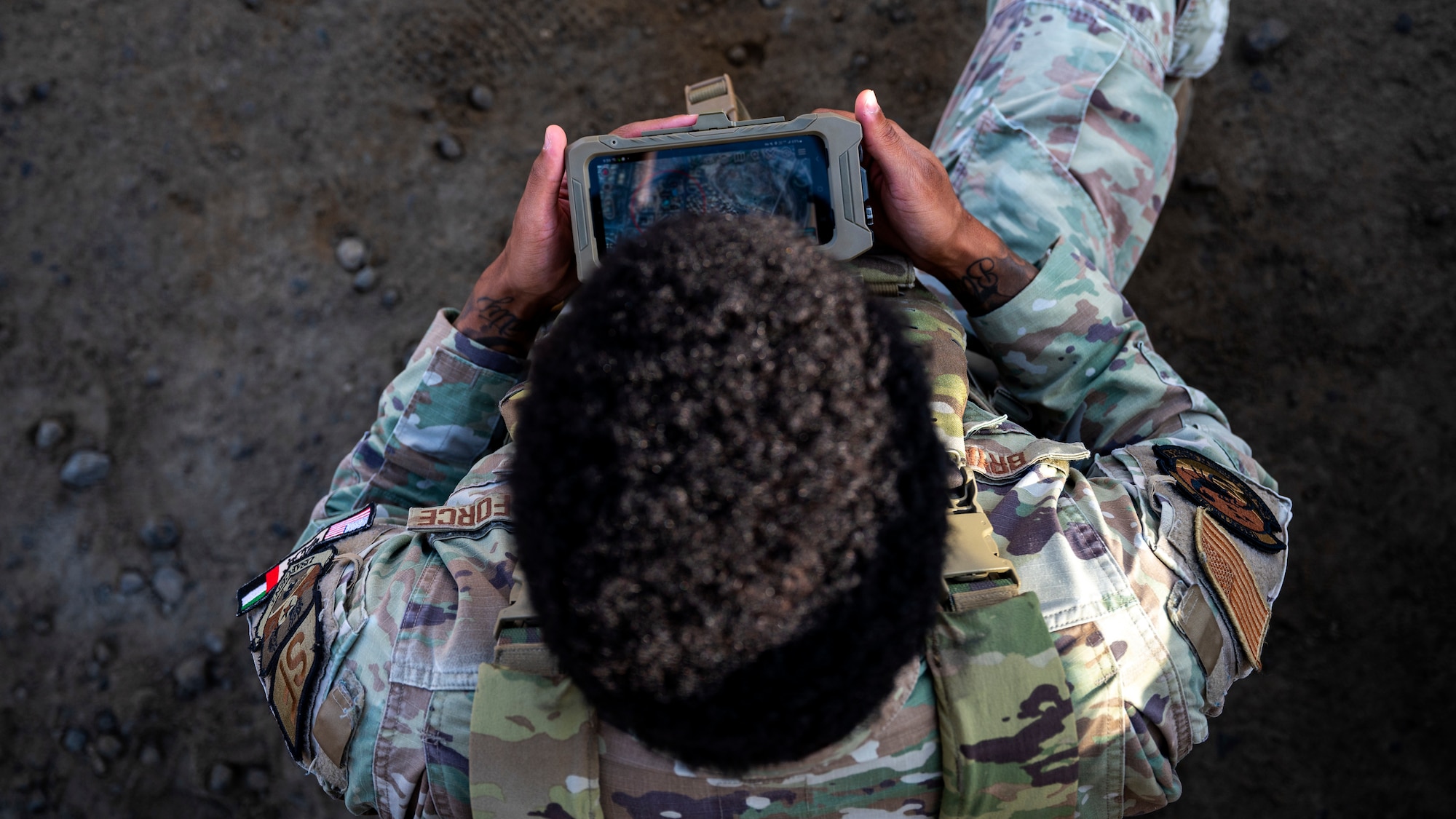 U.S. Air Force Senior Airman Sebastian Bryant, a security forces squadron defender, uses the Android Tactical Assault Kit (ATAK) system at an undisclosed location within the U.S. Central Command area of responsibility, Dec. 16, 2023. The ATAK provides defenders with improved communication and immediate situational awareness during base emergencies. (U.S. Air Force photo by Tech. Sgt. Sergio A. Gamboa)