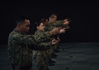 Recruits practice weapons handling and firing procedures during weapons familiarization training at the USS Missouri Small Arms Marksmanship Trainer (SAMT) at Recruit Training Command (RTC).