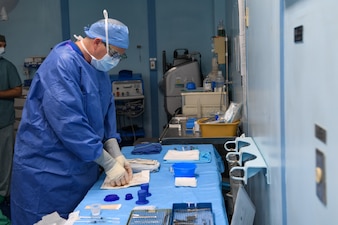 U.S. Navy Hospital Corpsman 2nd Class Joshua Franck, from San Diego, preps surgical instruments in an operating room aboard the hospital ship USNS Mercy (T-AH 19) anchored off of Koror, Palau, during Pacific Partnership 2024-1 Dec. 28, 2023.