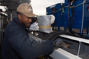 Aviation Boatswain’s Mate (Aircraft Handling) 3rd Class Julian Bibb, from Detroit, performs corrosion control on the flight deck aboard the U.S. Navy’s only forward-deployed aircraft carrier, USS Ronald Reagan (CVN 76), while in-port Commander, Fleet Activities Yokosuka, Dec. 27.