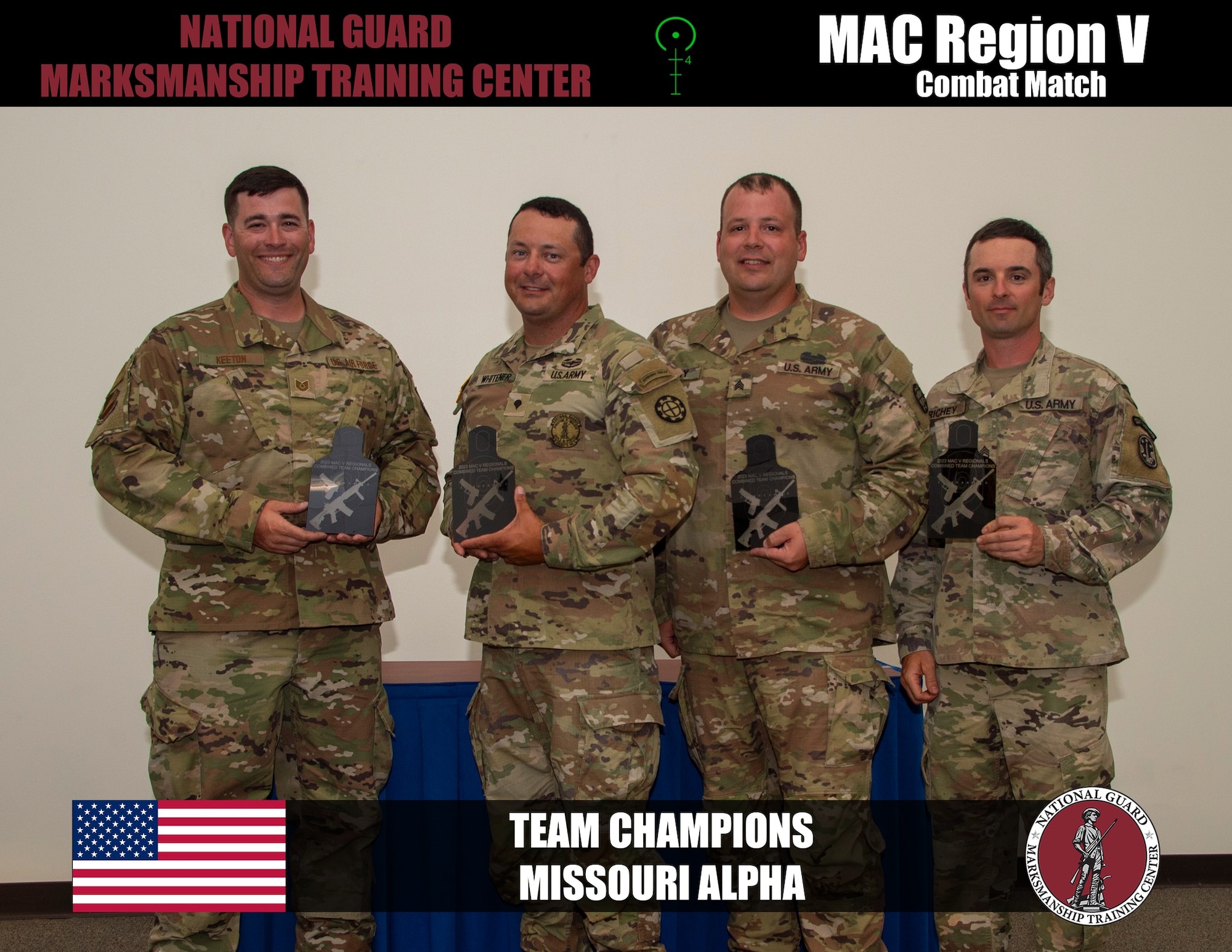 National Guard troops pose for a photo with trophies.