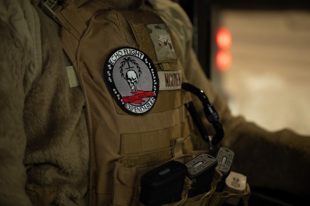 U.S. Air Force Airman Albert Nguyen, 354th Security Forces installation entry controller, stands by to check identification at the main gate on Eielson Air Force Base, Alaska, Dec. 27, 2023. The 354th SFS provides law enforcement and security services while safeguarding the base and transient aircraft. (U.S. Air Force photo by Airman Spencer Hanson)