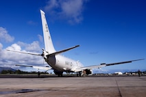 U.S. Navy Sailors tow a U.S. Navy P-8A Poseidon to a designated wash area after extraction from waters just off the runway at Marine Corps Air Station Kaneohe Bay, Marine Corps Base Hawaii, Dec. 4, 2023. The aircraft was relocated in preparation for decontamination of any potential foreign substances as well as salt water from its exterior. U.S. Navy Sailors and Marines worked with local and off-island specialists to recover the structurally intact P-8A Poseidon on Dec. 2, 2023; environmental protection measures were set in place, including 24/7 monitoring, containment booms, absorbent material, and a skimmer on standby during extraction. (U.S. Marine Corps photo by Lance Cpl. Hunter Jones)