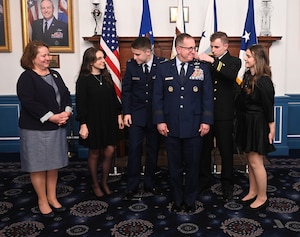 After being promoted to the position of Air Force Vice Chief of Staff, Gen. Jim Slife’s family pins his new rank on his uniform during his ceremony at Joint Base Anacostia-Bolling, Washington, D.C., Dec 29, 2023.