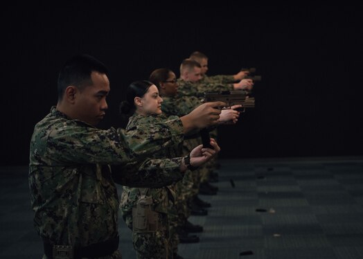  Recruits practice weapons handling and firing procedures during weapons familiarization training at the USS Missouri Small Arms Marksmanship Trainer (SAMT) at Recruit Training Command (RTC).