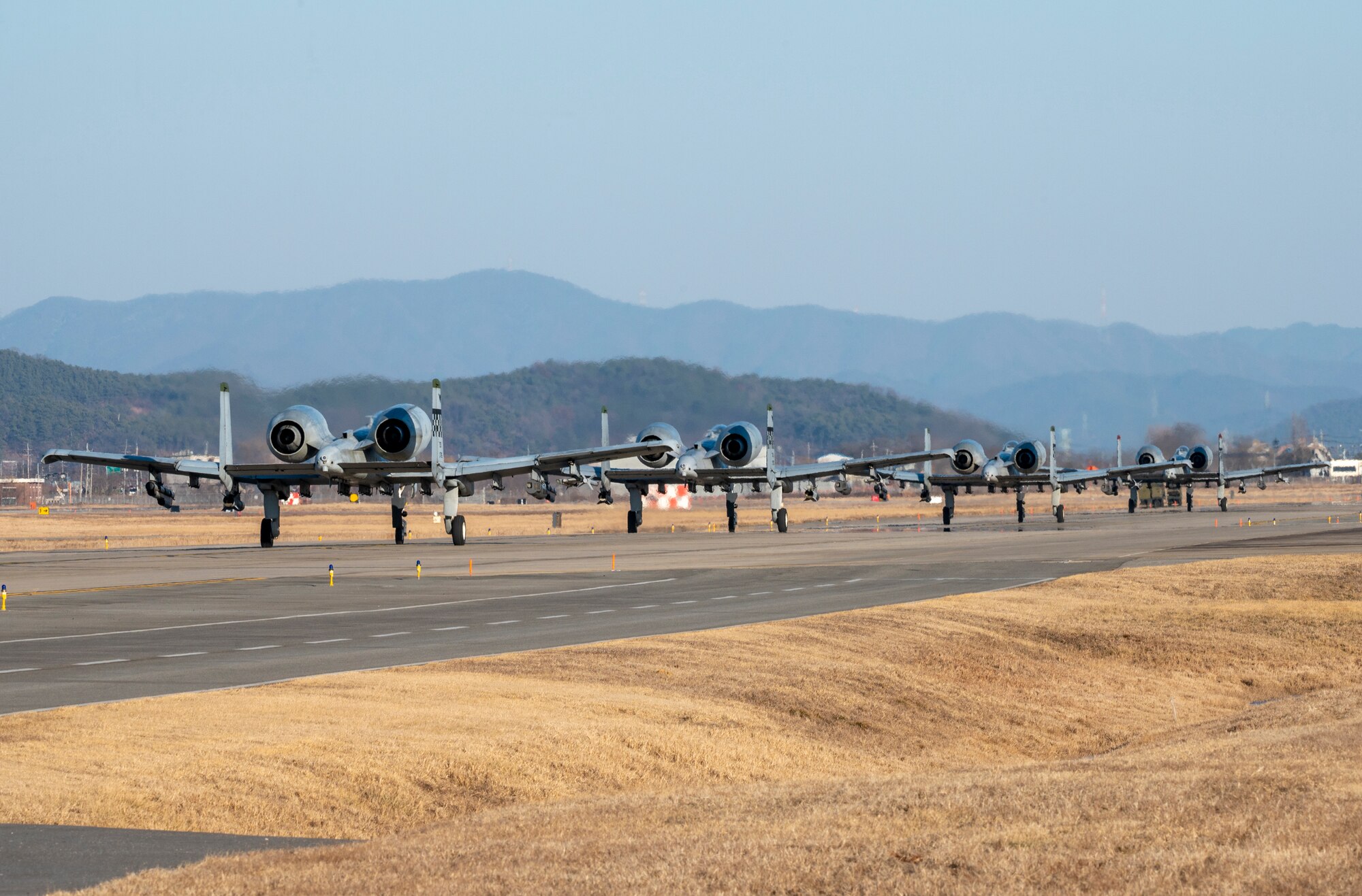A-10C Thunderbolt IIs, assigned to the 25th Fighter Squadron, taxi down the runway at Osan Air Base, Republic of Korea, Jan. 30, 2023. The aircraft took off as part of a week-long training event testing Osan’s ability to execute operations under realistic threat conditions. (U.S. Air Force Photo by Airman 1st Class Aaron Edwards)
