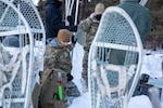 Attendees of the National Guard Arctic Interest Council observe the 133rd Contingency Response Flight, Minnesota Air National Guard, operating in extreme cold during the NG-AIC’s quarterly meeting at the Camp Ripley Training Center Jan. 25, 2023. The NG-AIC is a collaboration among states with arctic interests, capabilities, and resources to address the rapidly changing arctic environment.