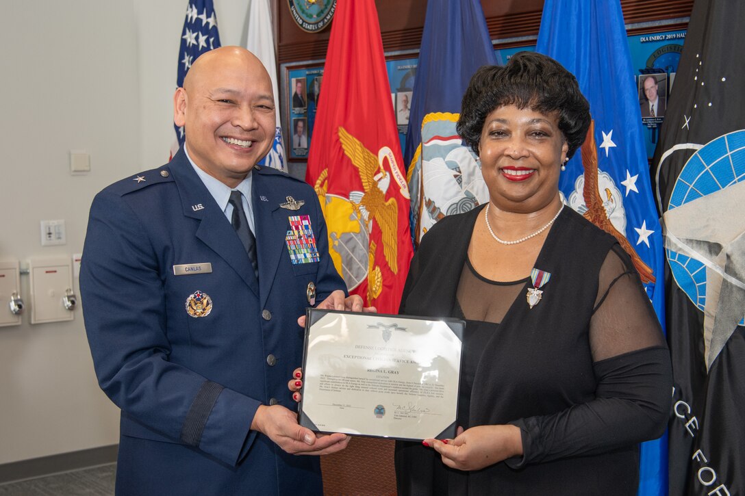 Air Force Brig. Gen. Jimmy Canlas presenting Regina Gray with the DLA Exceptional Civilian Service Award