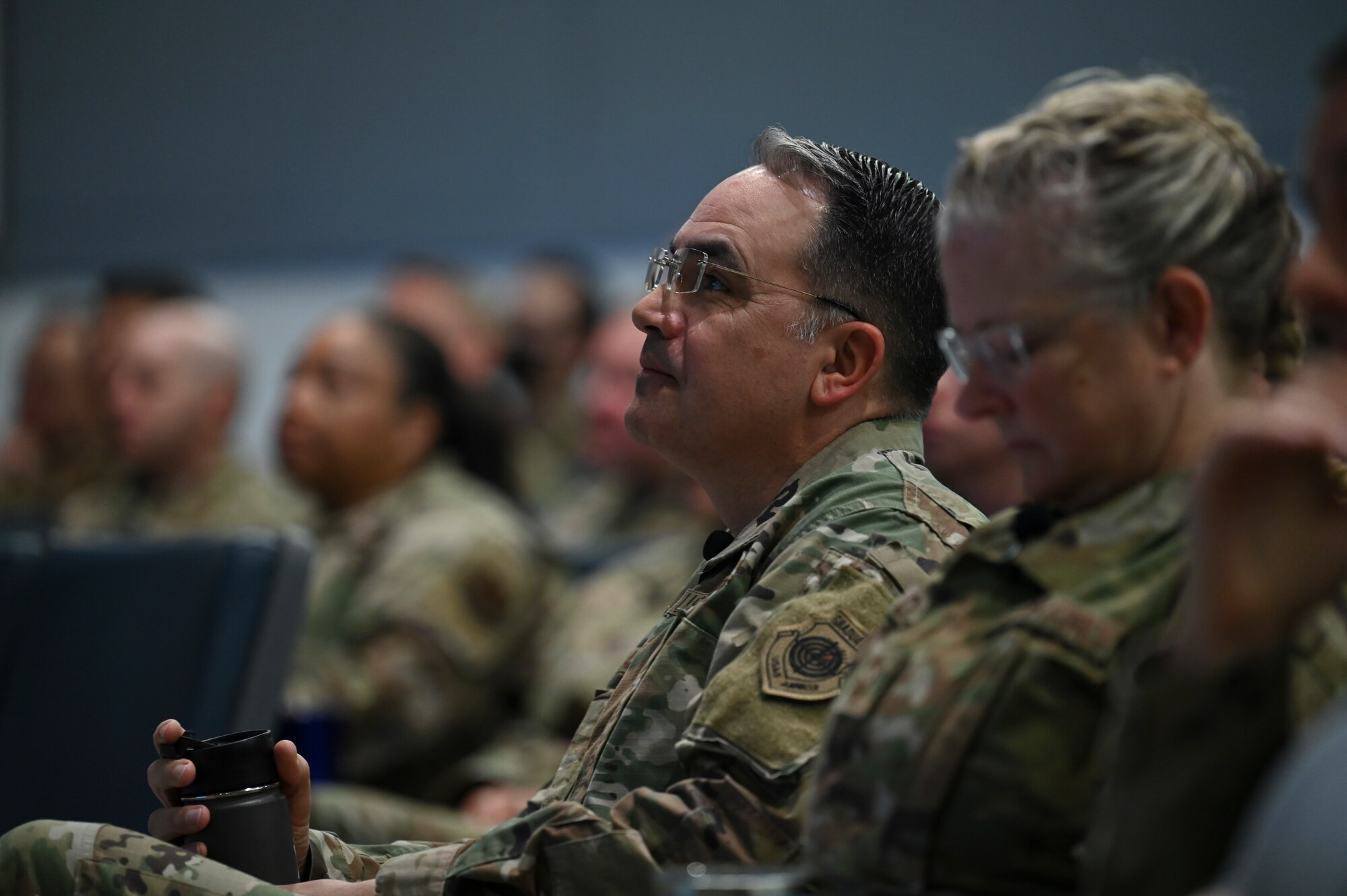 A man listens to a briefing.