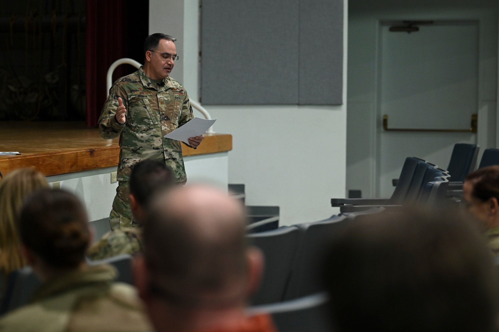 A man speaks to a group of people.