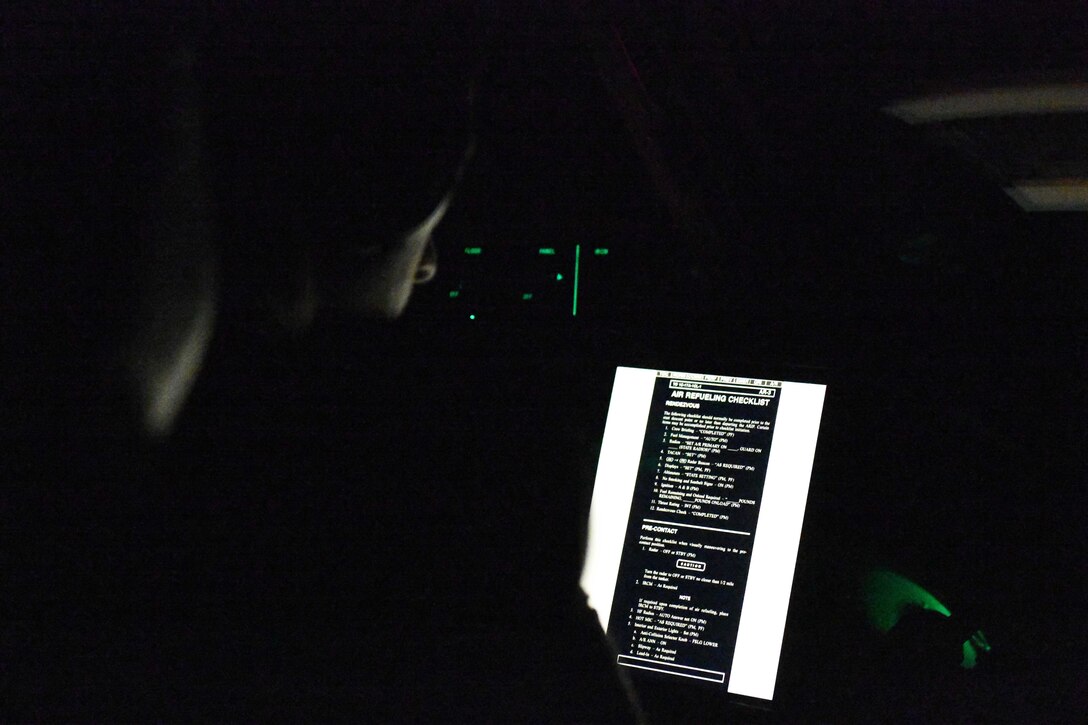 U.S. Air Force Capt. Dylan Radka, 58th Airlift Squadron instructor pilot, goes through an air refueling checklist prior to being refueled by a KC-135 Stratotanker during training near Travis Air Force Base, California, Jan. 24, 2023. Students performed a multitude of training exercises including night tactical arrival, tactical departures, night assault landing zone approaches and night aerial refueling. (U.S. Air Force photo by Airman 1st Class Miyah Gray)