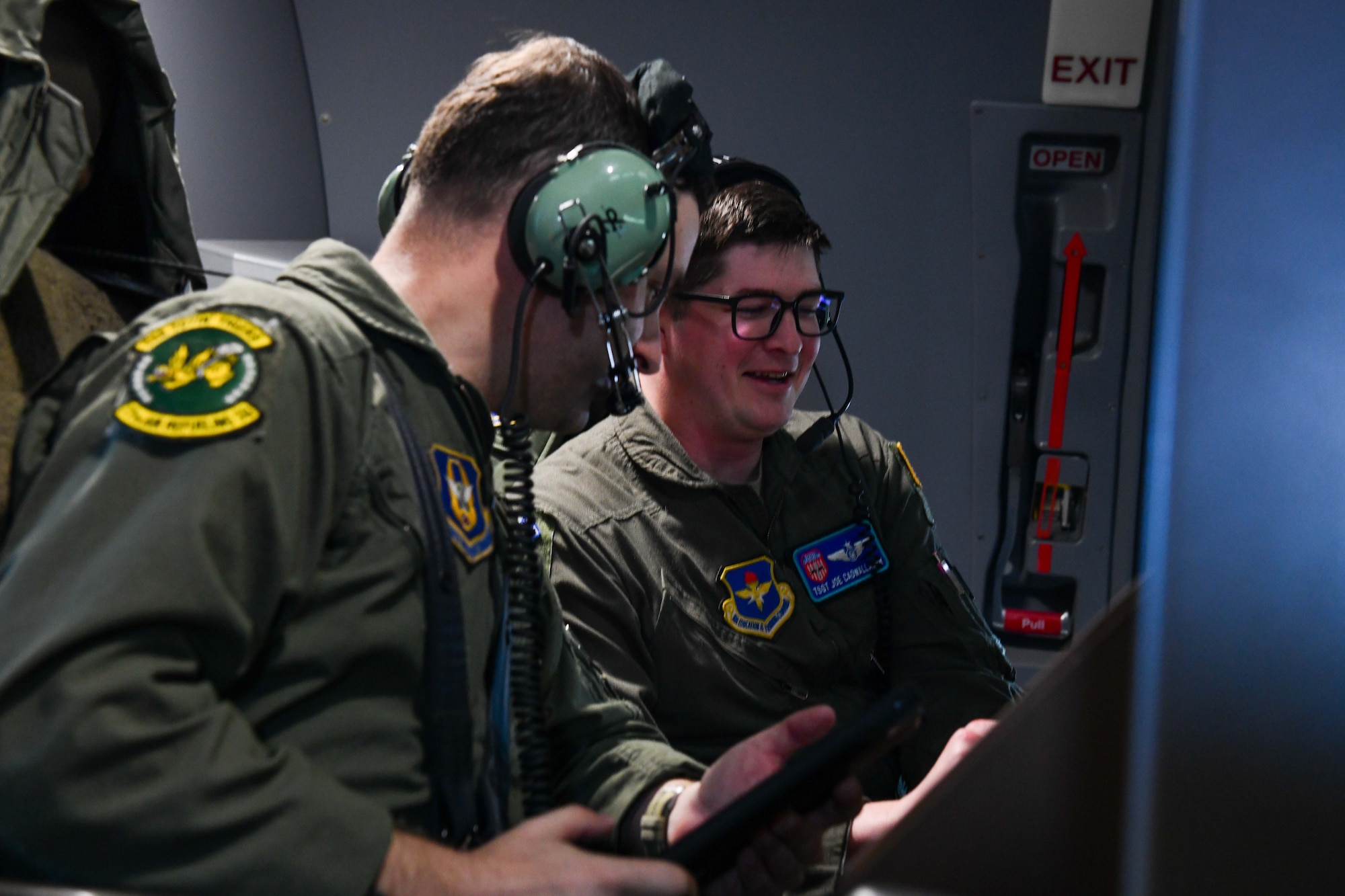 U.S. Air Force Tech. Sgt. Joseph Cadwallader, 56th Air Refueling Squadron (ARS) instructor boom operator, instructs Staff Sgt. Ralph Nickenson, 56th ARS student boom operator, while en route to Altus Air Force Base, Oklahoma, Jan. 25, 2023. Cadwallader explained receiver limits and distance calls for refueling another aircraft while in the KC-46 Pegasus. (U.S. Air Force photo by Airman 1st Class Miyah Gray)