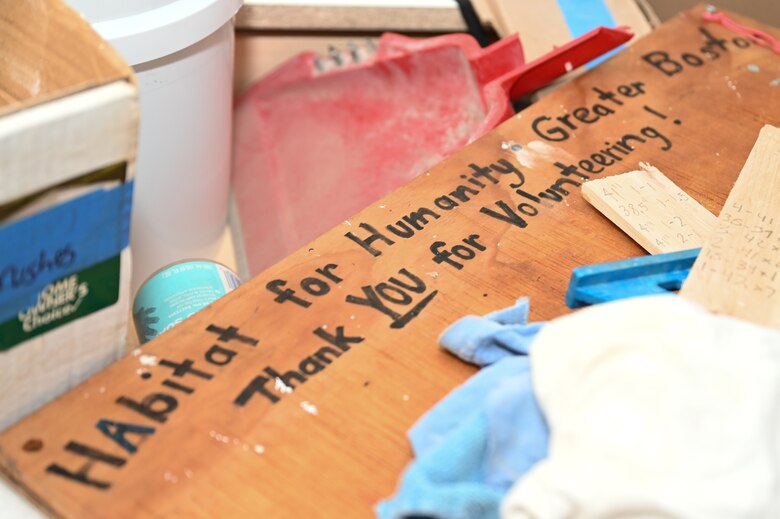 A sign thanking volunteers sits among items at a Habitat for Humanity house building project in Boston, Mass., Jan. 13. Members of the Hanscom Air Force Base, Mass., Company Grade Officers Council volunteered their time to help build a new duplex home as a way to give back to the community. (U.S. Air Force photo by Mark Herlihy)