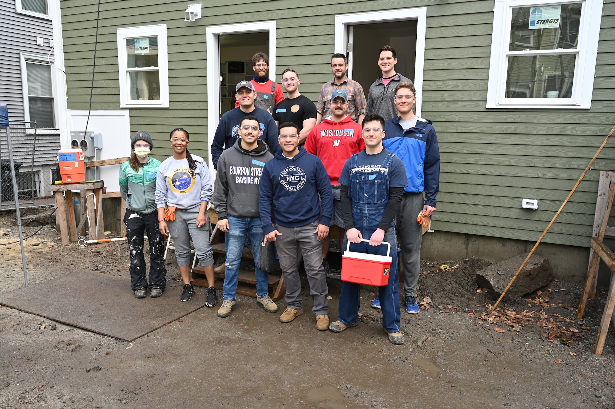 Members of the Hanscom Air Force Base, Mass., Company Grade Officers Council pose for a photo with Habitat for Humanity site supervisors during a home building project in Boston, Mass., January 13. Hanscom CGOC members volunteered their time to help build a new duplex home as a way to give back to the community. (U.S. Air Force photo by Mark Herlihy)