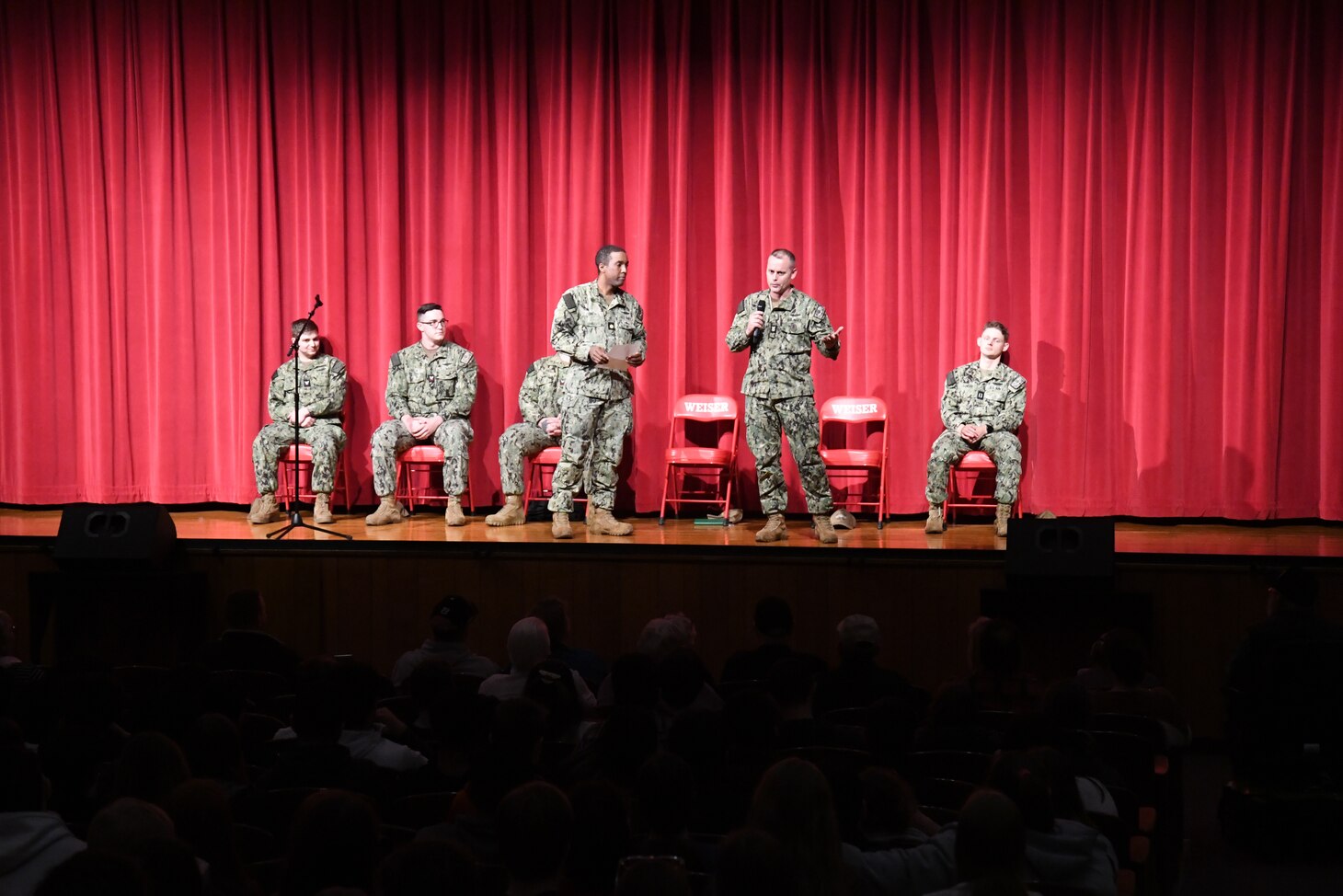 Lt. Cmdr. Darrell Smith, left, executive officer of the future USS Idaho (SSN 799), and Chief of the Boat Master Chief Travis Skipper speak with students at Weiser High School in Weiser, Idaho, Jan. 26.