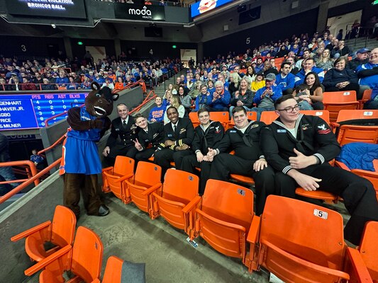 Crewmembers from the future USS Idaho (SSN 799) pose for a photo with Boise State University mascot Buster Bronco during a basketball game in Boise, Idaho, Jan. 24.