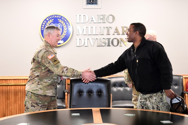 Maj. Gen. Michael Garshak, commanding general of the Idaho National Guard, welcomes Lt. Cmdr. Darrell Smith, executive officer of the future USS Idaho (SSN 799) during a visit to the base in Boise, Idaho, Jan. 26.