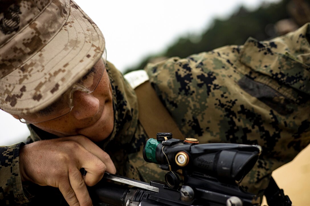 A Marine Corps recruit works on a weapon.