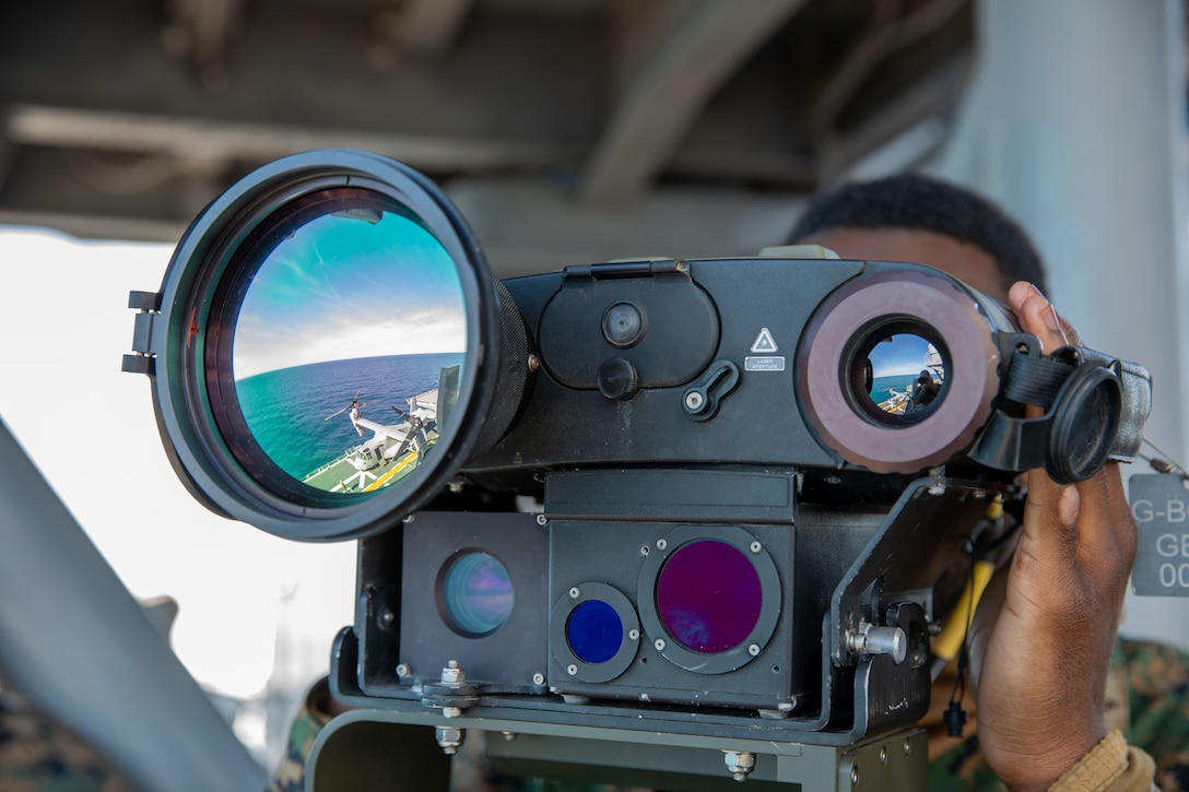 A Marine looks through a surveillance system viewfinder.