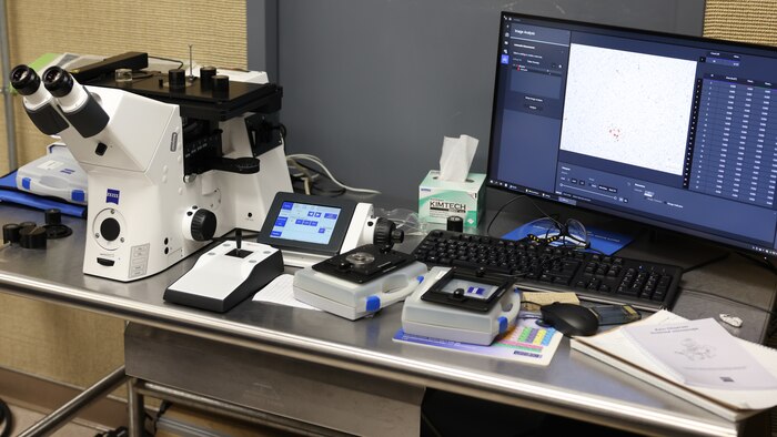Picture of microscope on table with computer monitor