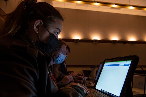Megan Runyan, Quinn Seys, and Parker Brown, 416th Flight Test Squadron weapons integration engineers, work together for data solutions during the Data Hackathon at Edwards Air Force Base, Calif., Nov. 3, 2021. The event was Air Force Test Center’s first Data Hackathon, solving data problems sponsored by U.S. Air Force Test Pilot School, with a goal to broaden the solution reach to have a bigger mission impact. (U.S. Air Force Tech. Sgt. Tabatha Arellano)