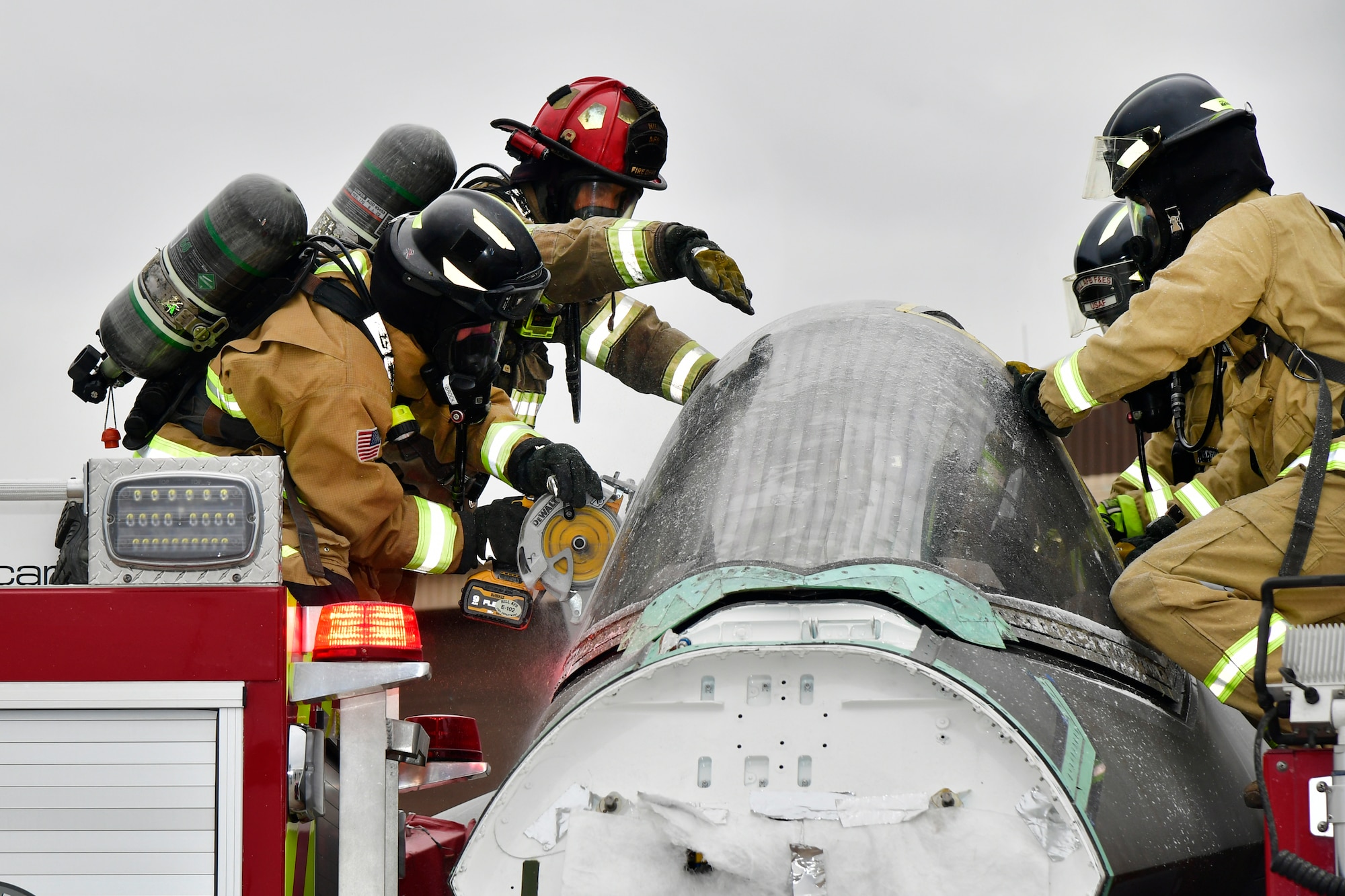 (Left to right) Firefighters with 775th Civil Engineering Squadron Fire Department and Firefighters from Eglin AFB, practice cutting into a salvaged canopy for the purpose of emergency aircrew extraction Jan. 24, 2023, at Hill Air Force Base, Utah. This was one of several scenarios practiced during an emergency responder working group exercise attended by first responders from across the Air Force to explore emergency engine shutdown and aircrew extraction best practices specific to F-35 aircraft. (U.S. Air Force photo by Todd Cromar)