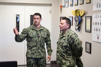 Chief of Naval Personnel Vice Adm. Rick Cheeseman, right, is given a tour of Naval Enlisted Aircrew Training School by Naval Aircrewmen Tactical Helicopter 1st Class Carl Daniel, from Walker, Louisiana, as part of a visit to Pensacola area Naval Education and Training Commands (NETC), Jan. 26, 2023. NETC's mission is to recruit, train and deliver those who serve our nation, taking them from street-to-fleet by transforming civilians into highly skilled, operational and combat ready warfighters. (United States Navy photo by courtesy asset)