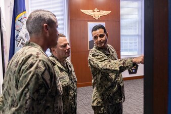 Chief of Naval Personnel Vice Adm. Rick Cheeseman, center, is given a tour of the Naval Aviation Schools Command’s (NASC) Area of Remembrance by Capt. Edgardo Moreno, right, NASC’s commanding officer, and Rear Adm. Pete Garvin, commander, Naval Education and Training Command (NETC), as part of a visit to Pensacola area NETC commands, Jan. 26, 2023. NETC's mission is to recruit, train and deliver those who serve our nation, taking them from street-to-fleet by transforming civilians into highly skilled, operational and combat ready warfighters. (United States Navy photo by Mass Communication Specialist 2nd Class Zachary Melvin)