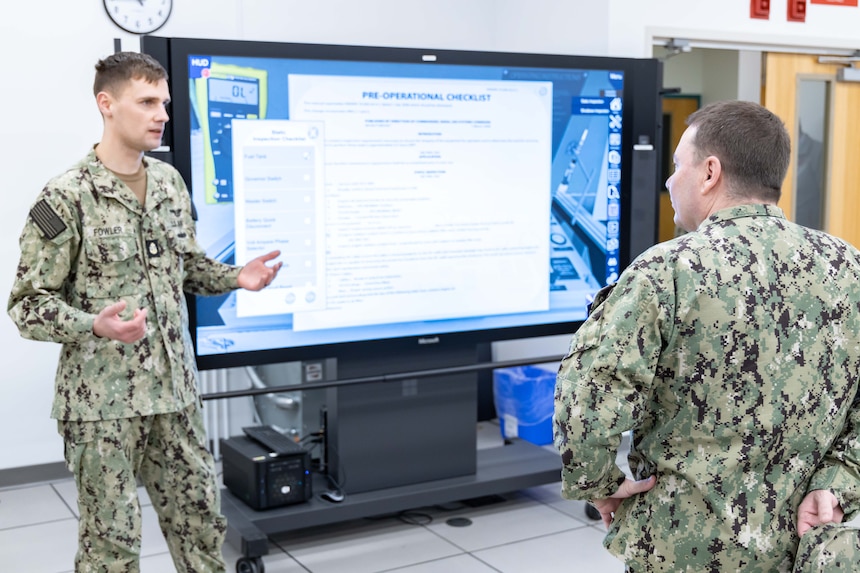 Chief of Naval Personnel Vice Adm. Rick Cheeseman, right, listens to a demonstration by Chief Aviation Support Equipment Technician Kyle Fowler, assigned to Naval Air Technical Training Center (NATTC), on the Multipurpose Reconfigurable Training System 3D® simulation during a tour of NATTC as part of a visit to Pensacola area Naval Education and Training Commands (NETC), Jan. 26, 2023. NETC's mission is to recruit, train and deliver those who serve our nation, taking them from street-to-fleet by transforming civilians into highly skilled, operational and combat ready warfighters. Multipurpose Reconfigurable Training System 3D®, MRTS 3D®, and the MRTS 3D logo are registered trademarks of the U.S. Navy. (United States Navy photo by Mass Communication Specialist 2nd Class Zachary Melvin)